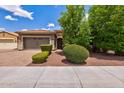 Charming home featuring a tile roof, manicured landscaping, and a spacious two-car garage at 2604 W Balao Dr, Phoenix, AZ 85085