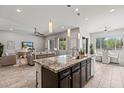 Open-concept kitchen featuring a center island that overlooks the living room and dining area at 2604 W Balao Dr, Phoenix, AZ 85085