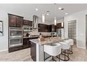 Modern kitchen with stainless steel appliances, granite countertops, and a large center island at 2604 W Balao Dr, Phoenix, AZ 85085