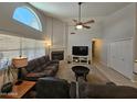 Comfortable living room with a fireplace, large window, and neutral-toned furniture at 2919 E Friess E Dr, Phoenix, AZ 85032