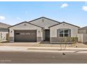 Charming single-story home featuring a two-car garage and desert landscaping in a peaceful neighborhood at 4035 S 176Th Dr, Goodyear, AZ 85338