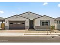 Charming single-story home featuring a two-car garage and desert landscaping in a peaceful neighborhood at 4035 S 176Th Dr, Goodyear, AZ 85338