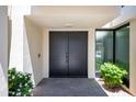 Stylish double doors and lush landscaping create a welcoming entrance to this modern home at 4336 E Piccadilly Rd, Phoenix, AZ 85018
