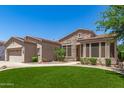 Well-maintained single-story home featuring manicured desert landscaping and stone accents on the facade at 4626 E Blue Spruce Ln, Gilbert, AZ 85298