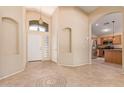 Welcoming foyer with neutral walls, tile flooring, archways, and views of the kitchen area at 4826 W Ardmore Rd, Laveen, AZ 85339