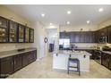 Spacious kitchen featuring dark cabinetry, a central island, and modern stainless steel appliances at 5014 E Kirkland Rd, Phoenix, AZ 85054