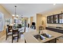 An open kitchen view showcasing the central island and seamlessly connects to the living room and outdoor spaces at 5014 E Kirkland Rd, Phoenix, AZ 85054