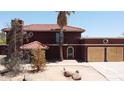 Two-story home featuring a Spanish tile roof, stucco exterior, and a well-manicured yard at 5716 E Desert Vista Trl, Cave Creek, AZ 85331