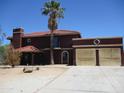 A two-story house showcases a red tile roof, desert landscaping, and an inviting entrance at 5716 E Desert Vista Trl, Cave Creek, AZ 85331