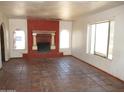 Living room area featuring decorative fireplace, tile flooring, and bright windows at 5716 E Desert Vista Trl, Cave Creek, AZ 85331