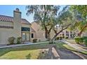 Attractive property showcasing manicured lawn, mature trees, and a classic stucco design at 602 N May -- # 17, Mesa, AZ 85201