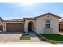 Charming single-story home featuring a well-manicured lawn, tile roof, and attached two-car garage at 6931 W Spur Dr, Peoria, AZ 85383