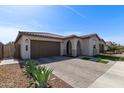 Beautiful single-story home showcasing desert landscaping, a tile roof, and an attached two-car garage at 6931 W Spur Dr, Peoria, AZ 85383