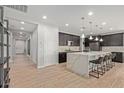 Modern kitchen featuring a large island with seating, dark cabinetry, and stainless steel appliances at 6931 W Spur Dr, Peoria, AZ 85383
