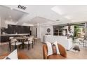 Modern living room with hardwood floors, a white couch, a kitchen and dining area in background at 7137 E Rancho Vista Dr # 4011, Scottsdale, AZ 85251