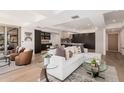 Open-concept living room featuring modern decor, light hardwood floors and neutral colors at 7137 E Rancho Vista Dr # 4011, Scottsdale, AZ 85251