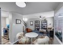 Open-concept living area featuring stylish furniture, a ceiling fan, and a staircase to the upper level at 7808 E Valley Vista Dr, Scottsdale, AZ 85250
