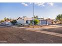 Corner lot home with desert landscaping and low maintenance yard with mature shade trees at 8021 W Hazelwood St, Phoenix, AZ 85033