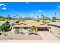 Aerial shot of a well-maintained single-story home with desert landscaping, mature trees, and a two-car carport at 8318 E Via De Los Libros --, Scottsdale, AZ 85258
