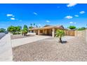 Beautiful single-story home with a two-car carport, desert landscaping, and a meticulously kept front yard at 8318 E Via De Los Libros --, Scottsdale, AZ 85258