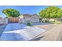 Well-maintained home with a three-car garage and a spacious driveway with gate at 8748 W Maui Ln, Peoria, AZ 85381