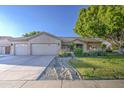 Lovely home with well-manicured landscaping, a three-car garage and charming curb appeal at 8748 W Maui Ln, Peoria, AZ 85381