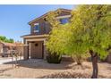 Eye-catching two-story home with well-kept landscaping, drought-resistant yard, and a cozy covered entryway at 8795 W Windsor Dr, Peoria, AZ 85381