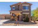 Charming front exterior of a two-story home with a well-maintained yard, lovely curb appeal, and a welcoming entrance at 8795 W Windsor Dr, Peoria, AZ 85381