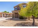 Beautiful two-story home with a manicured front yard, attractive desert landscaping, and a welcoming covered porch at 8795 W Windsor Dr, Peoria, AZ 85381