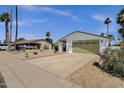 Well-kept single story home with a two-car garage, desert landscaping and an expansive driveway at 9330 E Kalil Dr, Scottsdale, AZ 85260