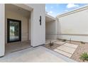 A stylish front porch with stone pavers and modern lighting fixtures at 9611 E Clinton St, Scottsdale, AZ 85260