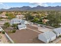 An aerial view showcasing the home, expansive grounds, and mountain views at 9821 E Larkspur Dr, Scottsdale, AZ 85260