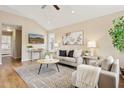Bright living room featuring a vaulted ceiling, stylish furniture, and a large decorative rug at 10015 E Mountain View Rd # 2034, Scottsdale, AZ 85258