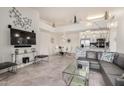 Open-concept living room with dining area and kitchen, featuring a large TV and modern decor at 10136 E Southern Ave # 3091, Mesa, AZ 85209