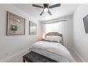 Cozy bedroom with a ceiling fan, plush carpet, and a comfortable queen-sized bed at 10849 S 175Th Dr, Goodyear, AZ 85338