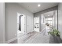 Inviting hallway with hardwood floors and neutral colors, leading to various rooms at 10849 S 175Th Dr, Goodyear, AZ 85338