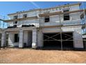 Unfinished two-story home exterior showing the garage entrance and scaffolding at 11444 E Utopia Ave, Mesa, AZ 85212