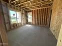 Bright interior featuring exposed beams, concrete floors, and natural light from two windows at 11444 E Utopia Ave, Mesa, AZ 85212