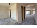 An unfinished living room shows open doorway frames, smooth concrete floors, and a great view to the outside at 11444 E Utopia Ave, Mesa, AZ 85212