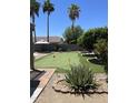 Putting green in a well landscaped backyard, perfect for outdoor leisure and relaxation at 12753 W Vista Paseo Dr, Litchfield Park, AZ 85340