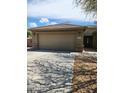 Home featuring a two-car garage, low maintenance landscaping, and tasteful stonework accents on the facade at 1333 E Cecil Ct, Casa Grande, AZ 85122