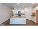 Open kitchen with granite countertops, stainless steel appliances, and a center island at 13523 W Remuda Dr, Peoria, AZ 85383