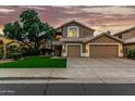 Charming two-story home featuring a well-manicured lawn and an attached three-car garage at 13566 N 93Rd Pl, Scottsdale, AZ 85260