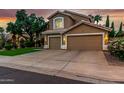 Charming two-story home featuring a well-manicured lawn and an attached three-car garage at 13566 N 93Rd Pl, Scottsdale, AZ 85260