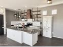 Modern kitchen featuring white cabinets, stainless steel countertops, open shelving, and a stylish wood range hood at 1492 S Pike Ln, Gilbert, AZ 85296