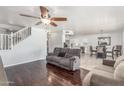 Open floor plan with living room, dining area, and kitchen with dark wood floors at 17235 W Statler St, Surprise, AZ 85388