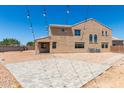 Spacious backyard featuring a large patio area, desert landscaping, and string lights at 18663 W Vogel Ave, Goodyear, AZ 85338