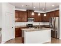 Modern kitchen featuring granite countertops, stainless steel appliances, and pendant lighting at 18663 W Vogel Ave, Goodyear, AZ 85338