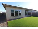Backyard featuring low maintenance artificial turf, covered patio and stucco wall at 19321 W Luke Ave, Litchfield Park, AZ 85340