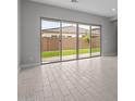 Bright living room featuring large sliding glass doors that provide backyard views and allow natural light to flood the space at 19321 W Luke Ave, Litchfield Park, AZ 85340